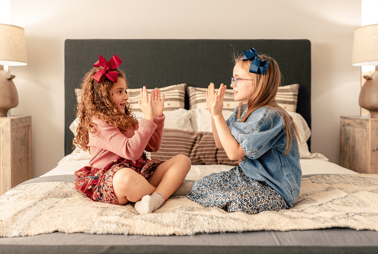 Girls clapping together in bed