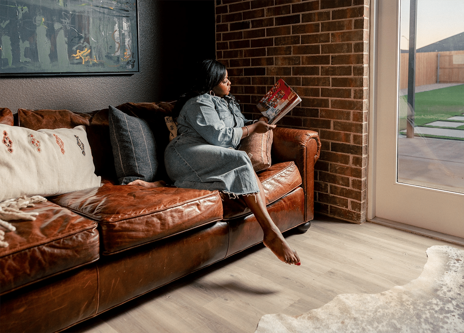 Woman reading book on couch