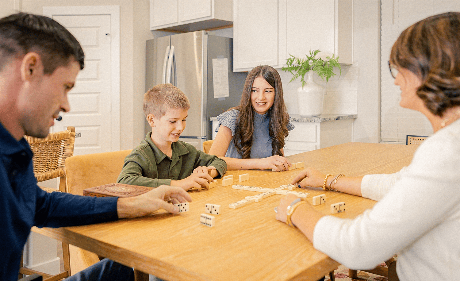 Family playing dominoes at their table