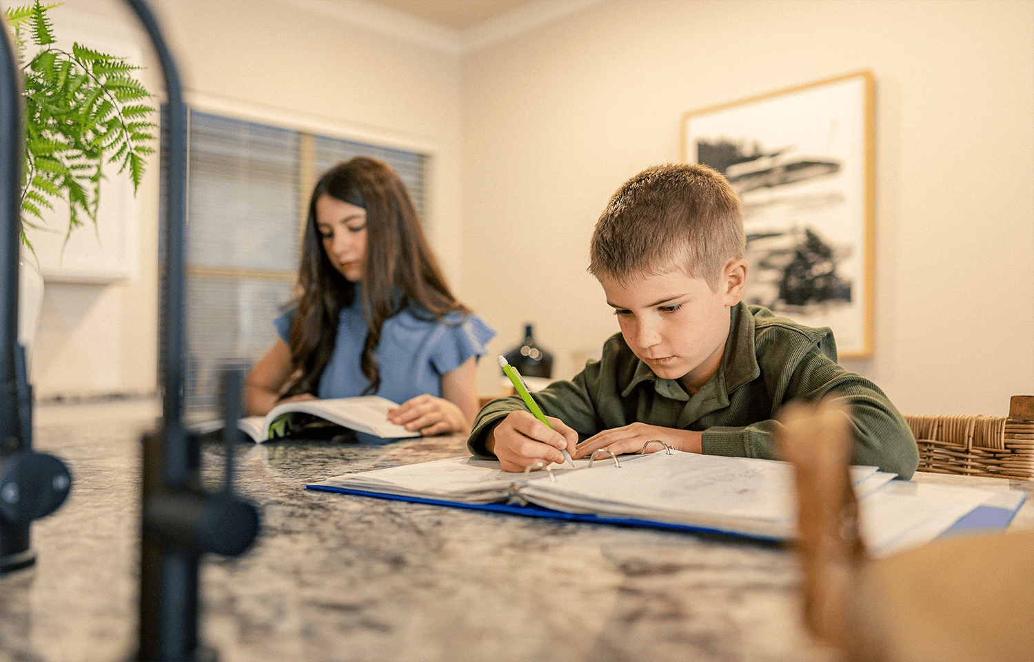 Kids doing their homework at a kitchen island