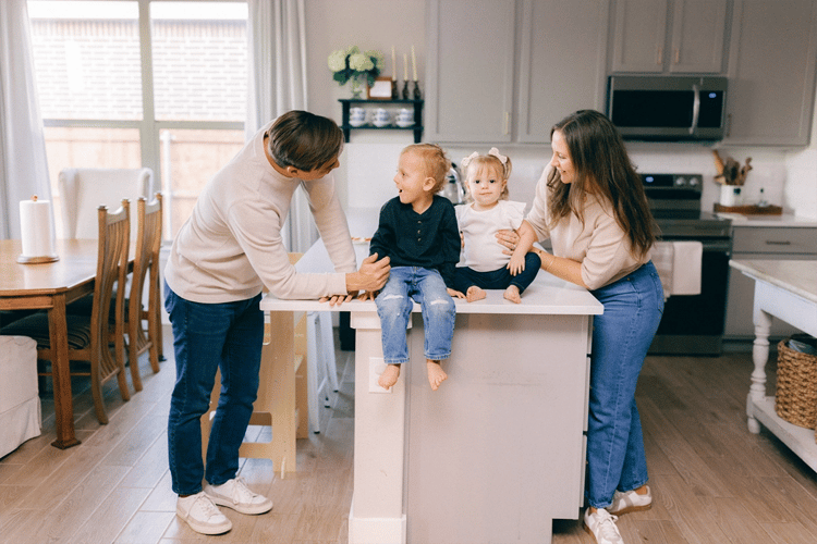 Young family smiling together in their kitchen