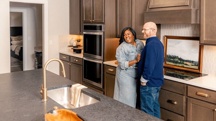 Couple laughing together in their kitchen