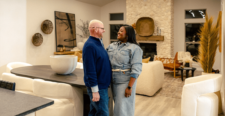 Couple smiling at each other in their living room