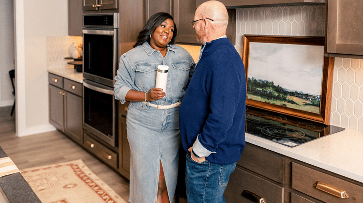 Happy Couple standing in their kitchen