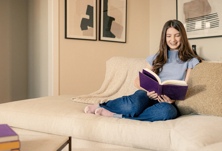 Girl reading her book on sofa