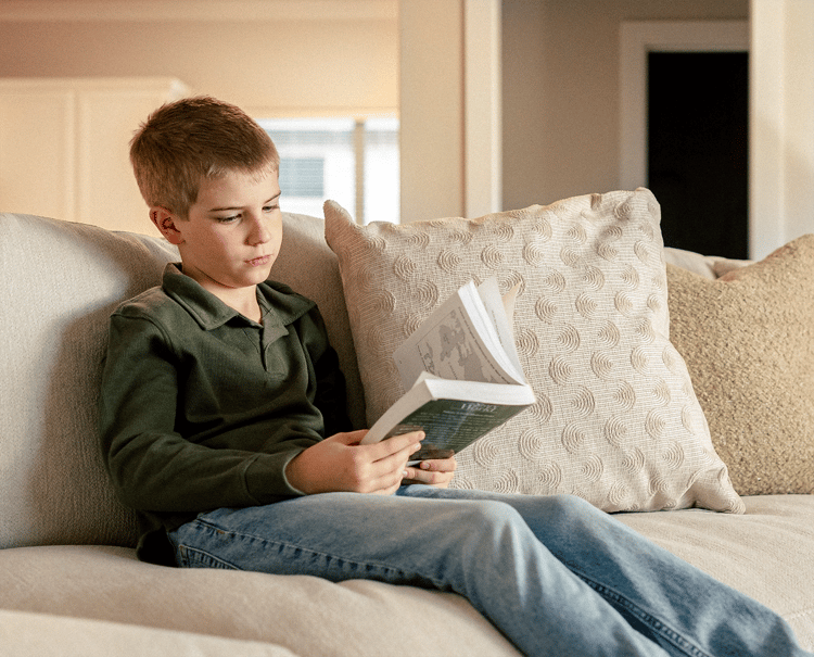 Boy reading on couch