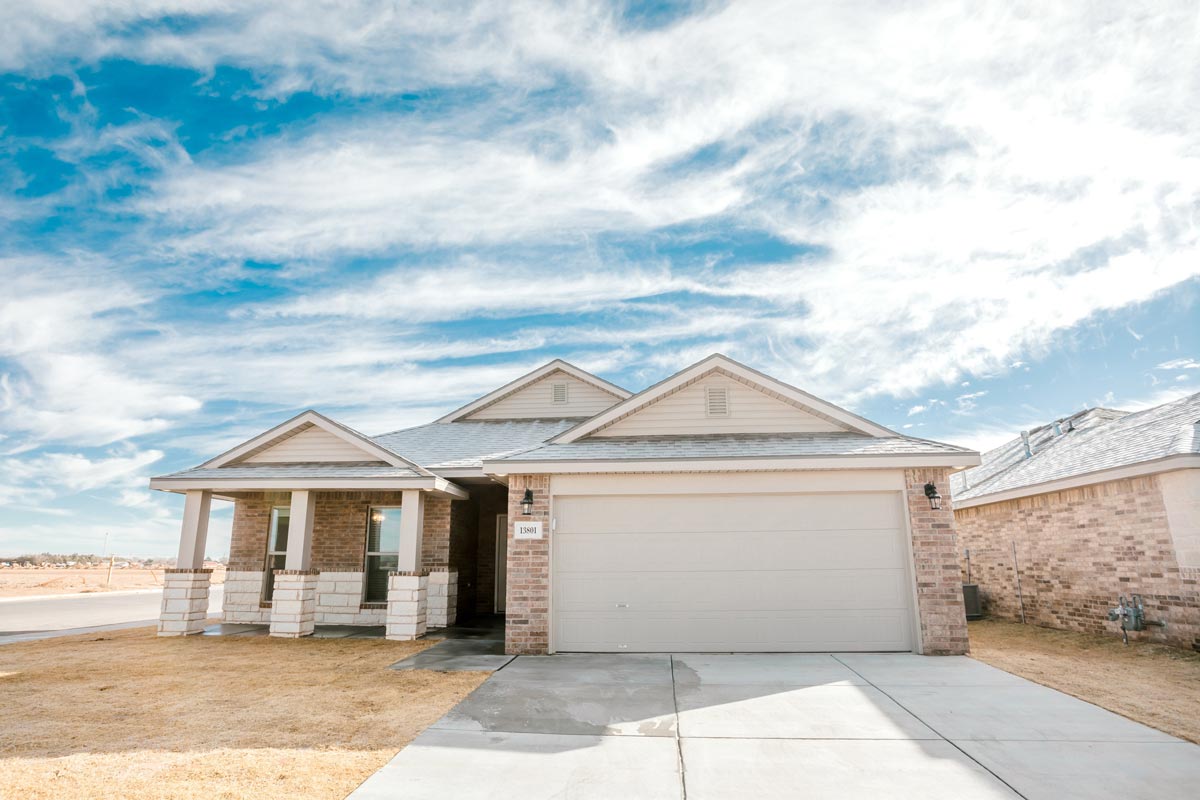 Photo of the exterior of a Betenbough home with a beautiful West Texas sky.