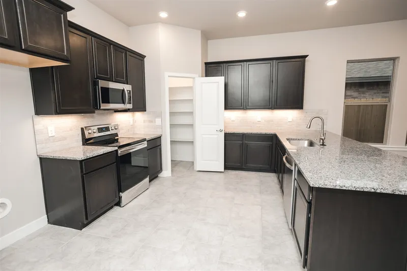 Photo of a Betenbough Homes kitchen and pantry.