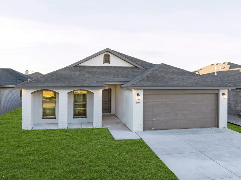 Photo of the beautiful exterior of a Betenbough Home under the West Texas sunset.