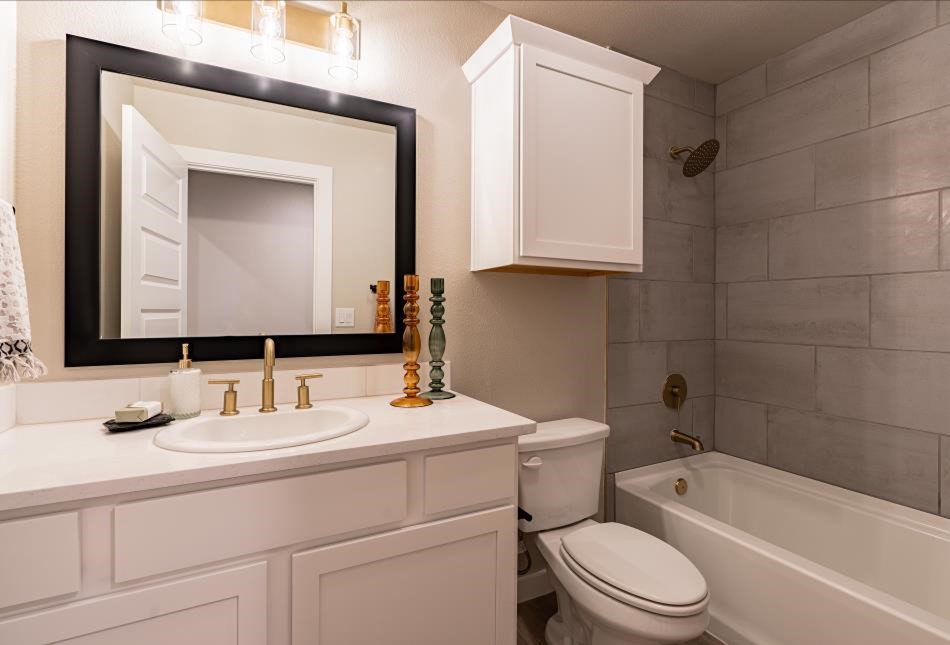 Photo of a bathroom in a Betenbough home, representing proper cleaning and maintenance of the sinks, tubs, and plumbing fixtures.