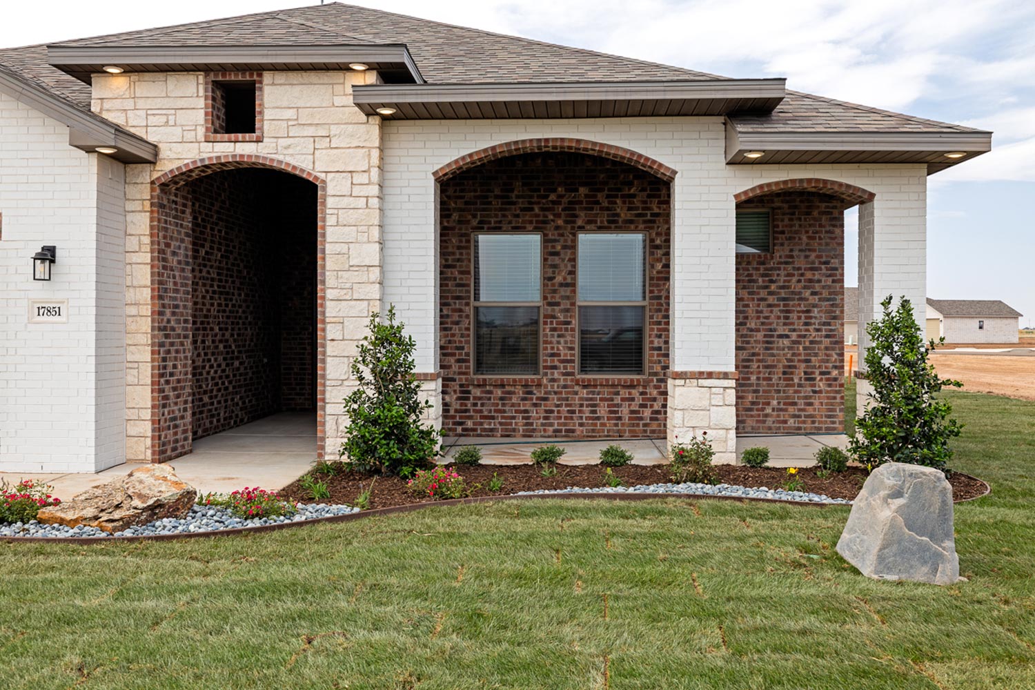 Photo of a Betenbough Home exterior with a healthy lawn and landscaping.