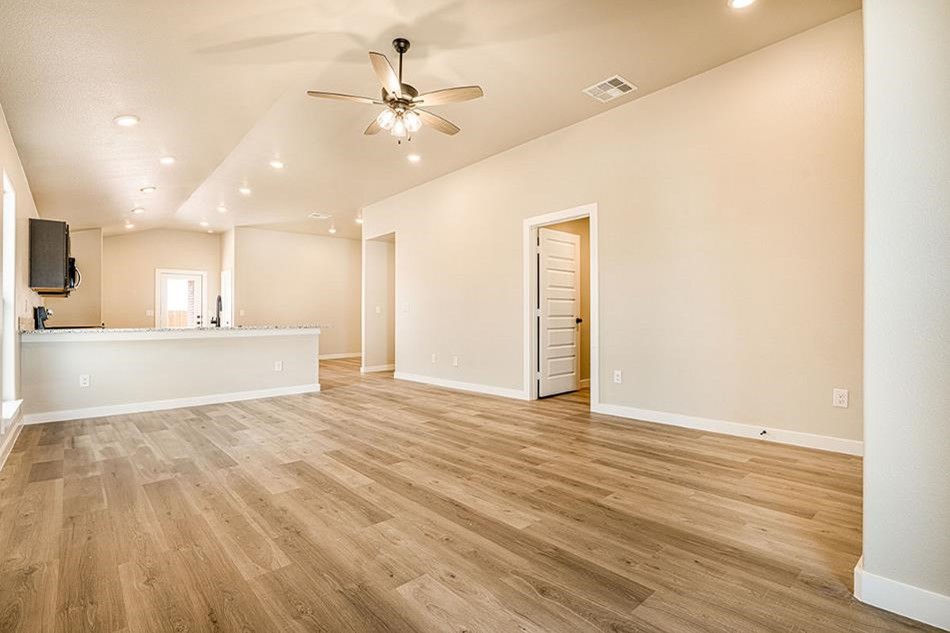 Photo of pet-friendly luxury vinyl plank flooring in a Betenbough home's living room.