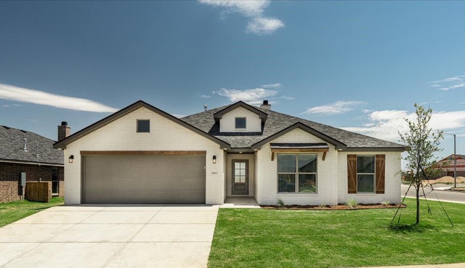 Photo of the exterior of a Betenbough Homes Heidi floor plan with green grass and a blue sky.