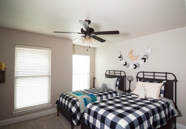 Photo of two twin beds made with black and white gingham bedspreads.