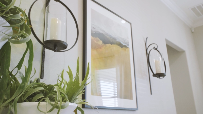 Photo of art and candles on a wall in a new model home.