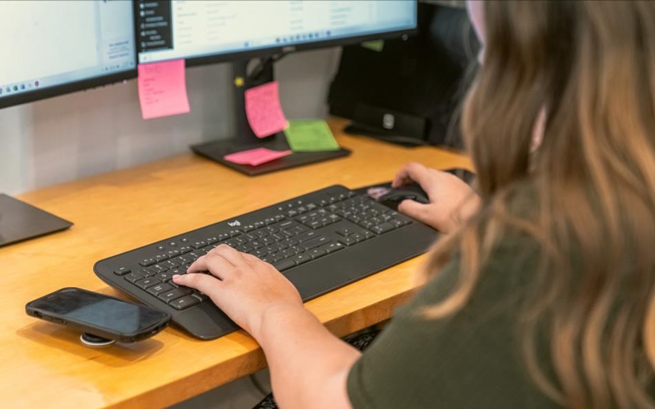 Photo of a person working at a desk.