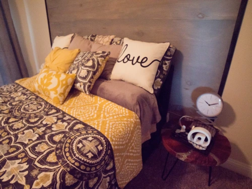 Photo of a bedside table with a clock and other decor.