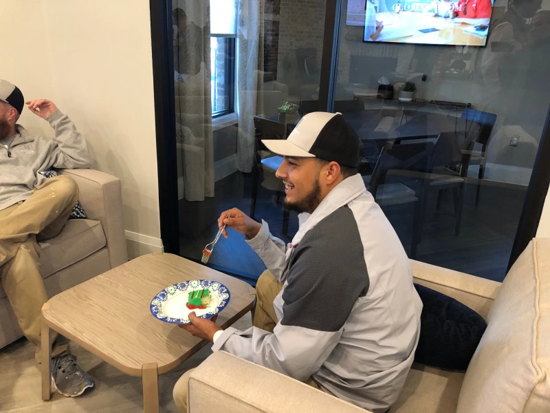 Photo of a Betenbough Homes team member enjoying a slice of cake.