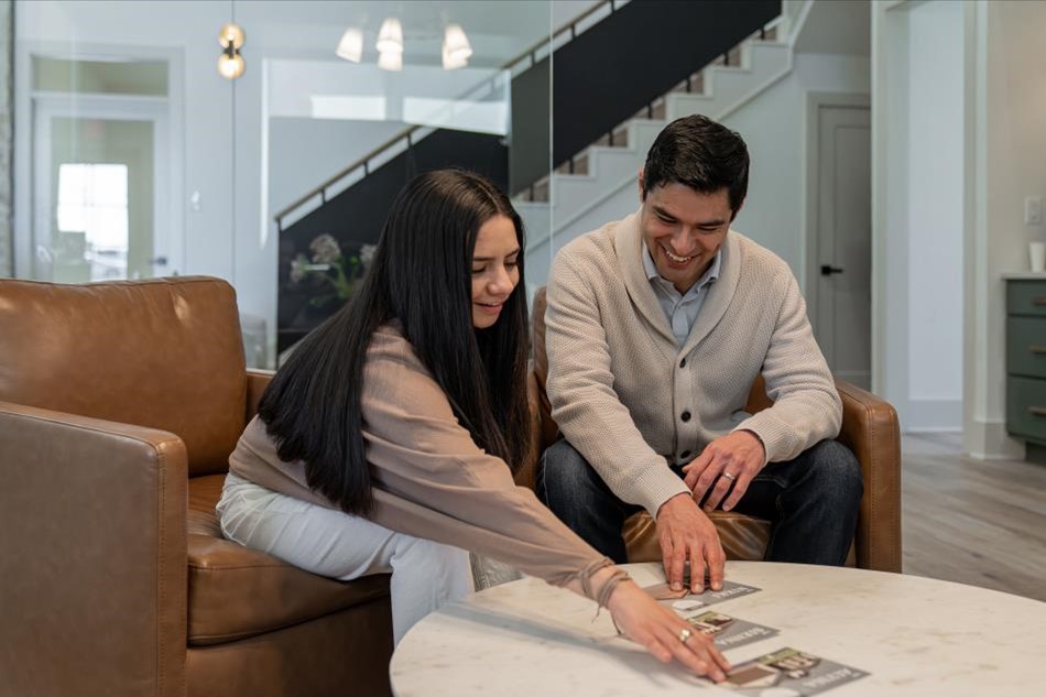 Photo of home buyers looking at different Betenbough Homes floor plans.