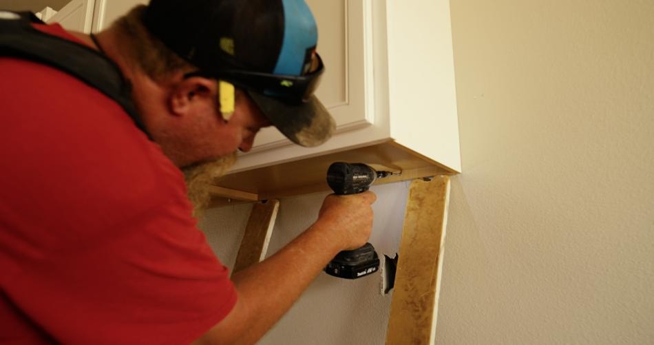 Photo of a warranty team member doing warranty work on a Betenbough home.