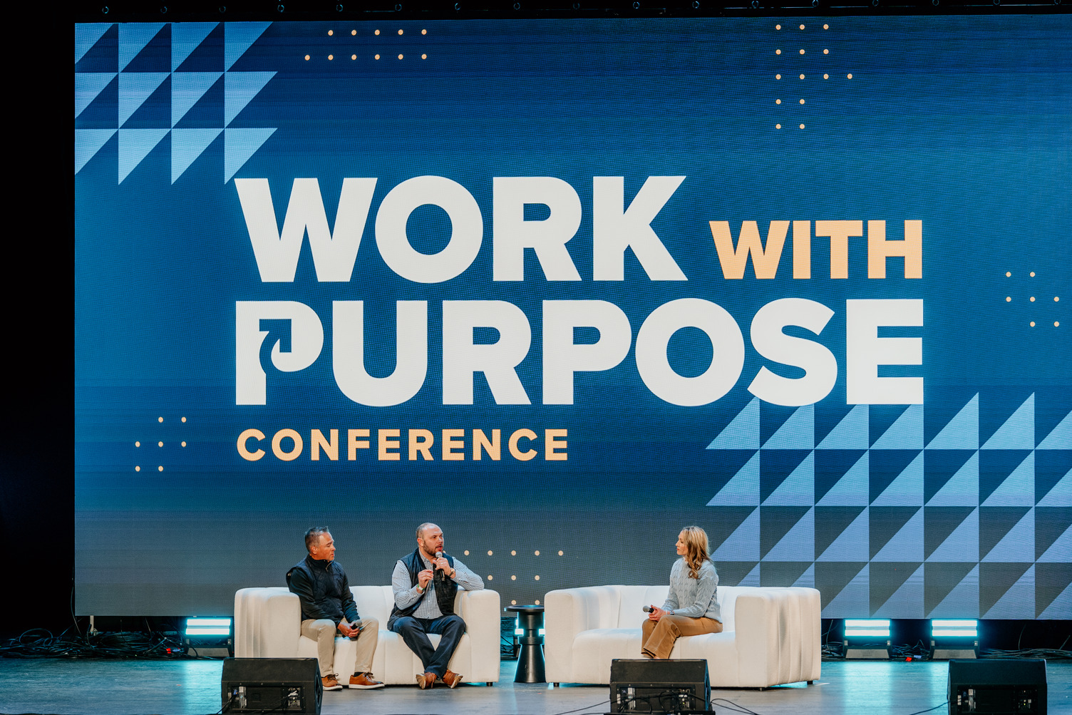 Photo of a panel discussion on stage at Kingdom at Work's Work With Purpose Conference.